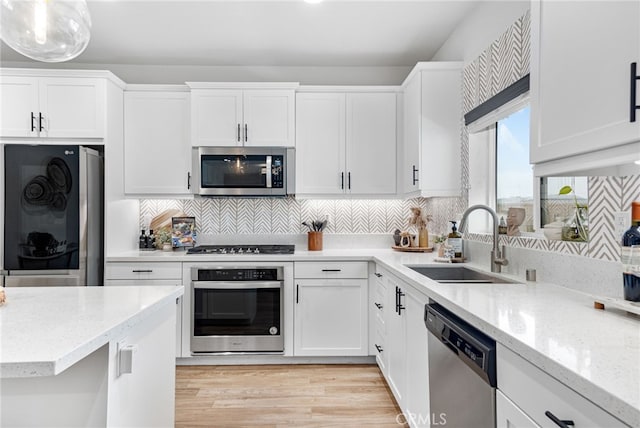 30893 Telegraph Dr, Winchester, CA 92596 - kitchen with appliances with stainless steel finishes, a sink, white cabinets, and light stone countertops
