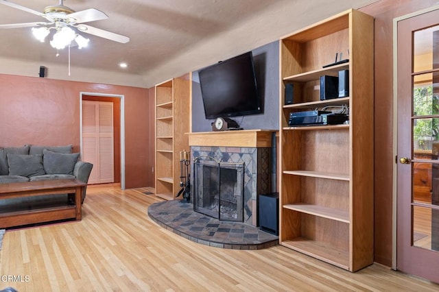 339 2nd St, Fillmore, CA 93015 - living room with wood finished floors, built in shelves, a fireplace with raised hearth, and ceiling fan