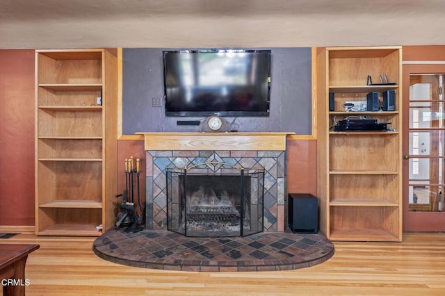 339 2nd St, Fillmore, CA 93015 - detailed view of wood finished floors, built in shelves, and a fireplace with raised hearth