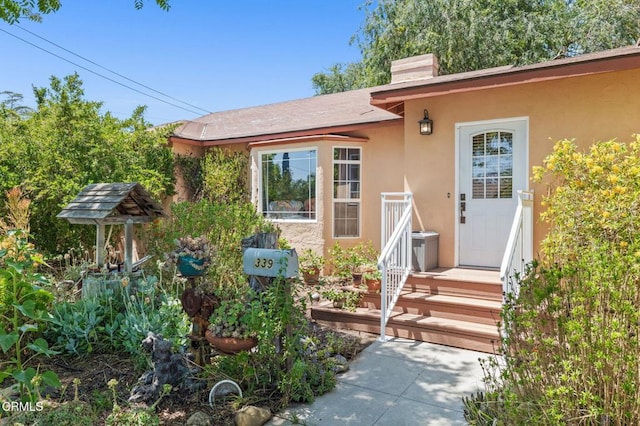 339 2nd St, Fillmore, CA 93015 - doorway to property with stucco siding and a chimney