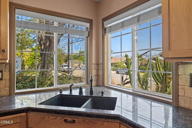 339 2nd St, Fillmore, CA 93015 - kitchen featuring a sink, dark stone countertops, tasteful backsplash, and brown cabinets