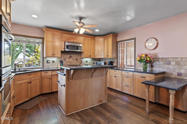 339 2nd St, Fillmore, CA 93015 - kitchen featuring a sink, stainless steel appliances, a kitchen bar, decorative backsplash, and ceiling fan