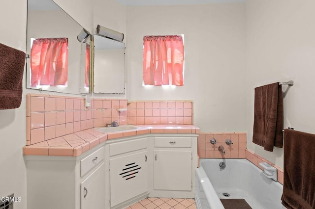 339 2nd St, Fillmore, CA 93015 - bathroom with a garden tub, vanity, decorative backsplash, and tile patterned flooring