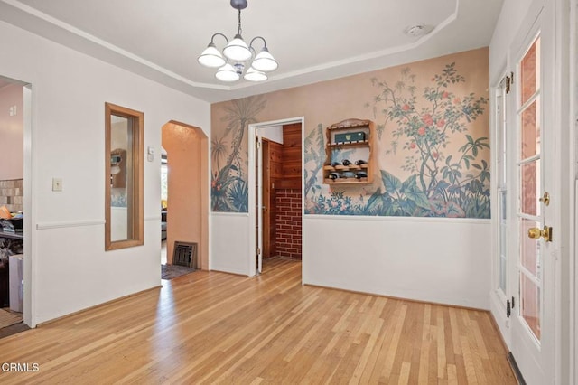 339 2nd St, Fillmore, CA 93015 - unfurnished dining area with wainscoting, a chandelier, light wood finished floors, a tray ceiling, and wallpapered walls