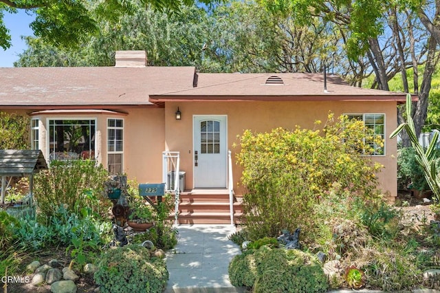339 2nd St, Fillmore, CA 93015 - view of front of home with stucco siding, roof with shingles, and a chimney