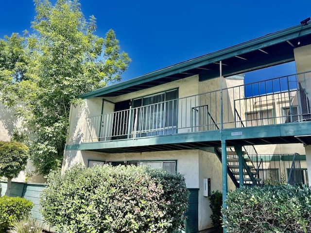 1817 E Grand Ave Unit 72, Escondido, CA 92027 - back of property featuring stucco siding, stairs, and a balcony