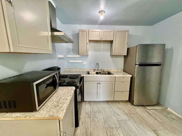 1817 E Grand Ave Unit 72, Escondido, CA 92027 - kitchen with freestanding refrigerator, a sink, wall chimney exhaust hood, black electric range oven, and light countertops