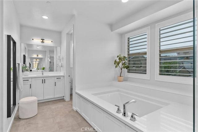 40 Jarano St, Rancho Mission Viejo, CA 92694 - bathroom featuring a garden tub, vanity, recessed lighting, and tile patterned flooring