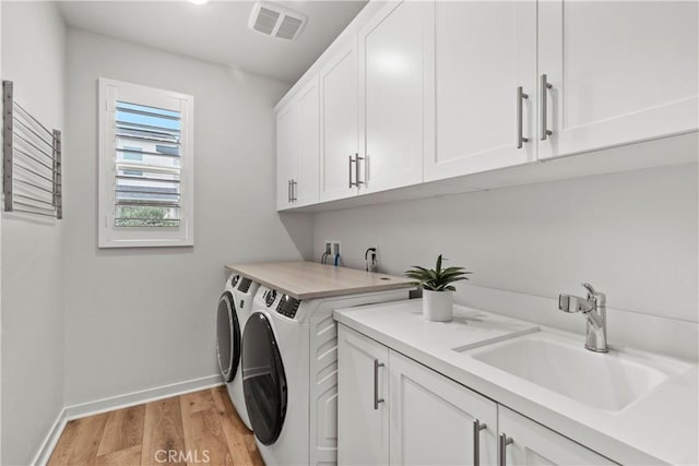 40 Jarano St, Rancho Mission Viejo, CA 92694 - laundry room with washing machine and dryer, cabinet space, baseboards, and light wood-style floors