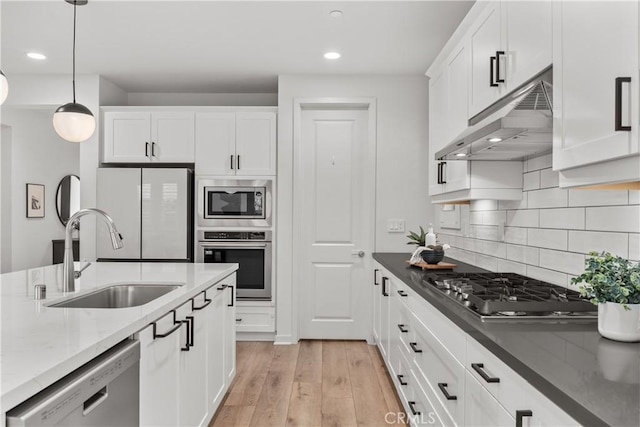 40 Jarano St, Rancho Mission Viejo, CA 92694 - kitchen with under cabinet range hood, appliances with stainless steel finishes, a sink, white cabinets, and recessed lighting
