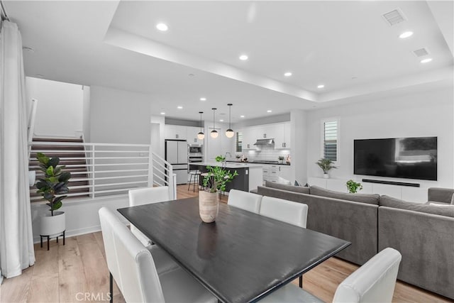 40 Jarano St, Rancho Mission Viejo, CA 92694 - dining space featuring stairway, recessed lighting, a raised ceiling, and light wood finished floors