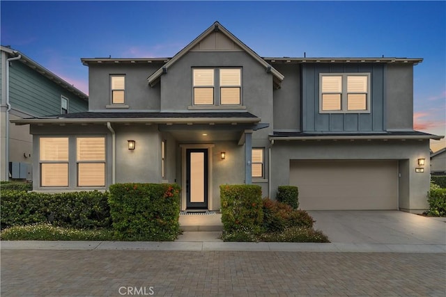 40 Jarano St, Rancho Mission Viejo, CA 92694 - view of front of property featuring stucco siding, a garage, concrete driveway, and board and batten siding