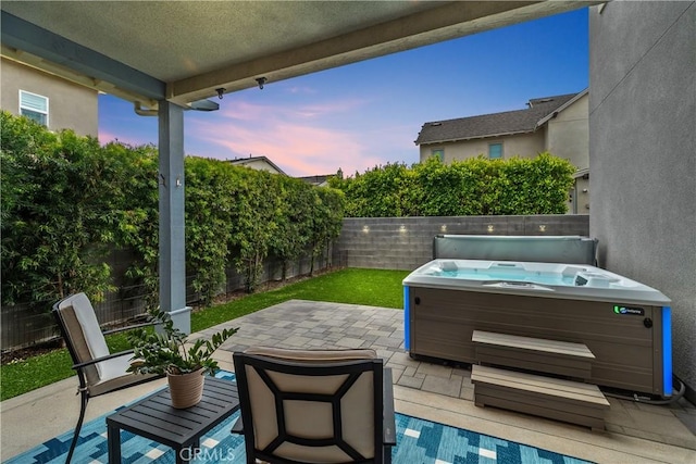 40 Jarano St, Rancho Mission Viejo, CA 92694 - patio terrace at dusk with a hot tub, a patio, and a fenced backyard