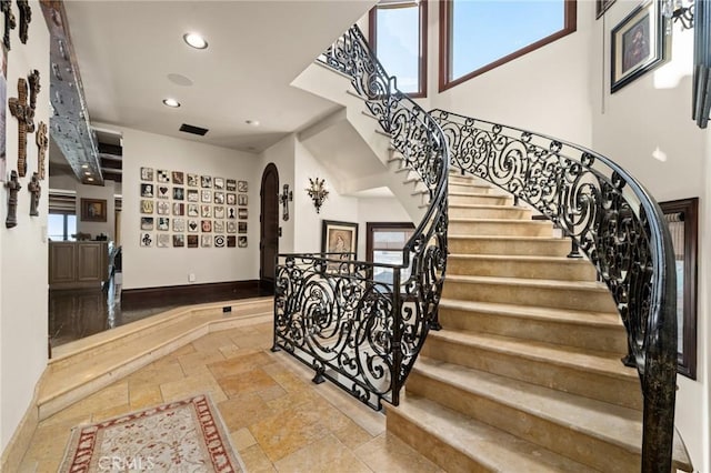 2 60th Pl, Long Beach, CA 90803 - stairs with stone tile floors, arched walkways, recessed lighting, a high ceiling, and baseboards