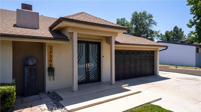 17206 Nugent Pl, Granada Hills, CA 91344 - property entrance featuring french doors, concrete driveway, stucco siding, a garage, and a chimney