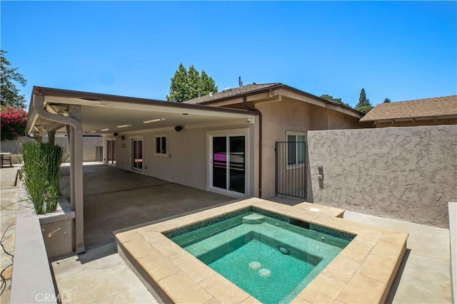 17206 Nugent Pl, Granada Hills, CA 91344 - rear view of property with stucco siding, an in-ground hot tub, and a patio