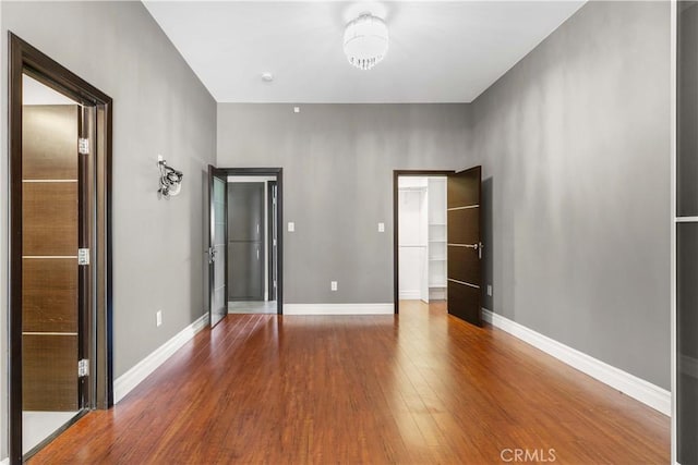 17206 Nugent Pl, Granada Hills, CA 91344 - unfurnished bedroom featuring wood finished floors and baseboards