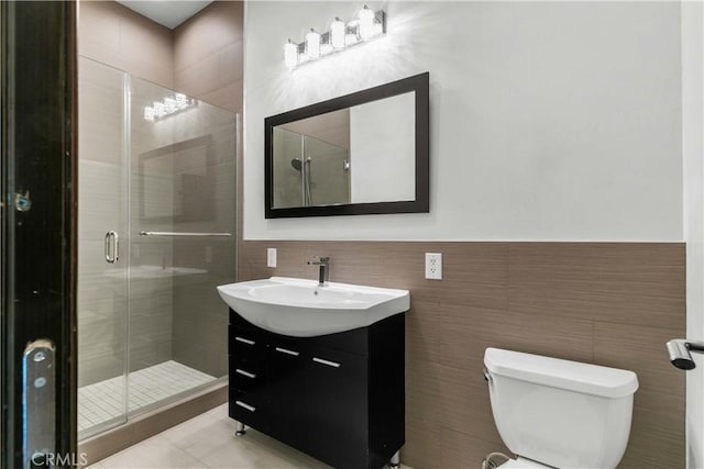 17206 Nugent Pl, Granada Hills, CA 91344 - full bath with tile walls, vanity, a shower stall, toilet, and wainscoting
