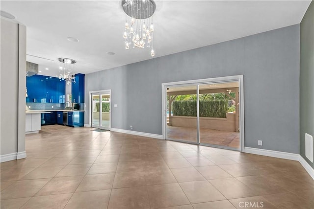 17206 Nugent Pl, Granada Hills, CA 91344 - unfurnished living room with a chandelier, plenty of natural light, tile patterned flooring, and baseboards