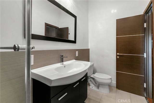 17206 Nugent Pl, Granada Hills, CA 91344 - half bath with vanity, tile patterned floors, toilet, and tile walls