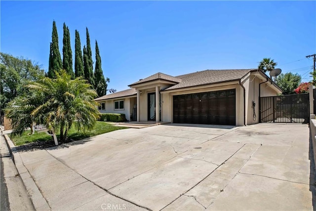 17206 Nugent Pl, Granada Hills, CA 91344 - view of front of property with a garage, stucco siding, and driveway
