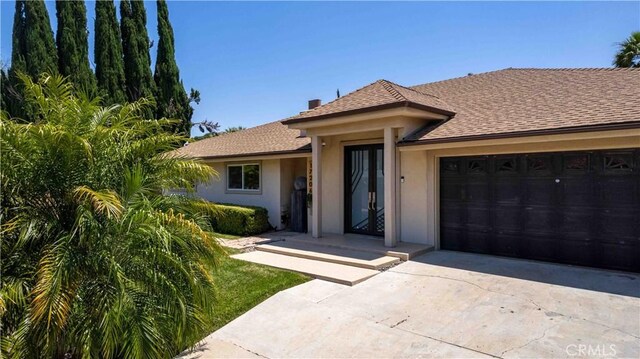 17206 Nugent Pl, Granada Hills, CA 91344 - single story home with driveway, a garage, stucco siding, and roof with shingles