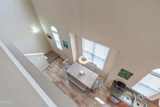 143 W Colorado Blvd, Monrovia, CA 91016 - living area featuring a towering ceiling, light wood-style floors, and baseboards