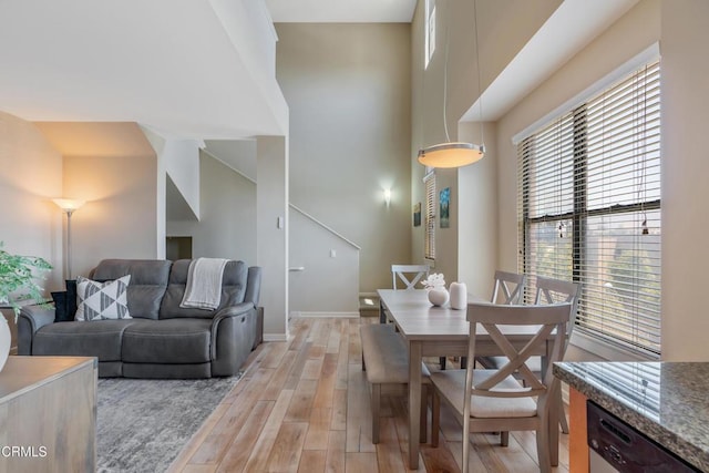 143 W Colorado Blvd, Monrovia, CA 91016 - dining area with light wood-type flooring, baseboards, and a towering ceiling