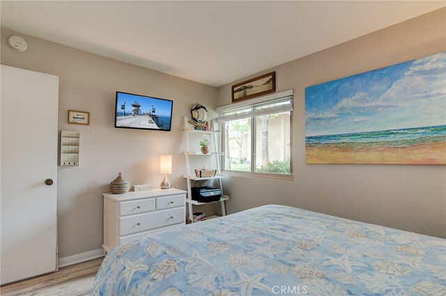 8788 Coral Springs Ct Unit 206A, Huntington Beach, CA 92646 - bedroom with light wood finished floors and baseboards