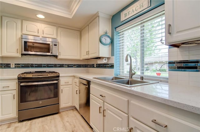 8788 Coral Springs Ct Unit 206A, Huntington Beach, CA 92646 - kitchen featuring appliances with stainless steel finishes, a sink, decorative backsplash, white cabinets, and recessed lighting