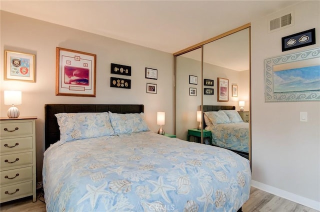 8788 Coral Springs Ct Unit 206A, Huntington Beach, CA 92646 - bedroom with light wood finished floors, a closet, and baseboards