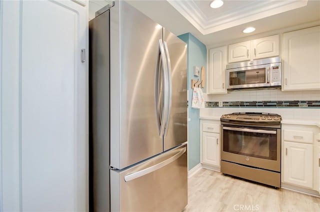 8788 Coral Springs Ct Unit 206A, Huntington Beach, CA 92646 - kitchen featuring appliances with stainless steel finishes, tasteful backsplash, white cabinets, recessed lighting, and light countertops