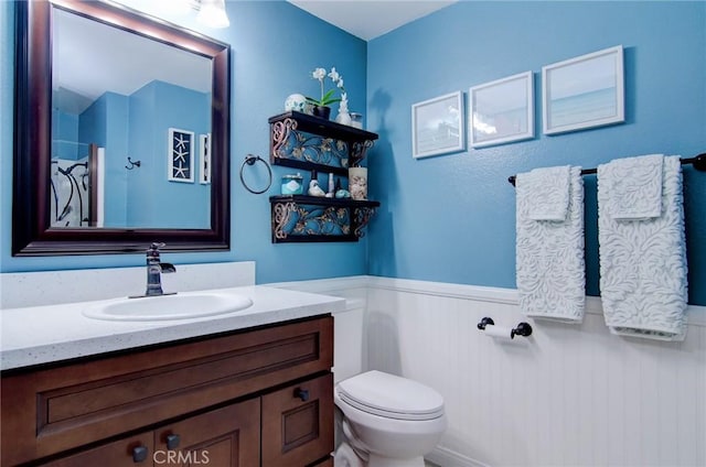8788 Coral Springs Ct Unit 206A, Huntington Beach, CA 92646 - bathroom with wainscoting, vanity, and toilet