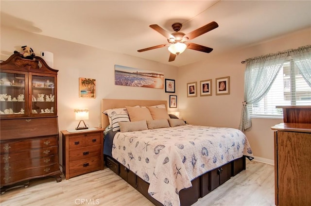8788 Coral Springs Ct Unit 206A, Huntington Beach, CA 92646 - bedroom with light wood-style flooring and ceiling fan