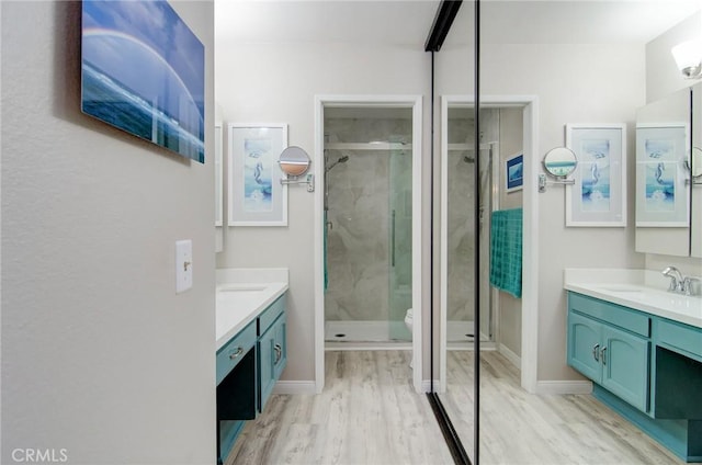 8788 Coral Springs Ct Unit 206A, Huntington Beach, CA 92646 - full bathroom featuring wood finished floors, a stall shower, and vanity