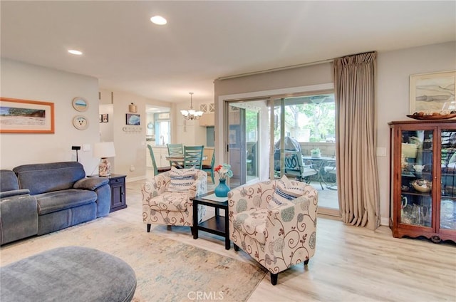 8788 Coral Springs Ct Unit 206A, Huntington Beach, CA 92646 - living room featuring a chandelier, light wood-type flooring, recessed lighting, and baseboards