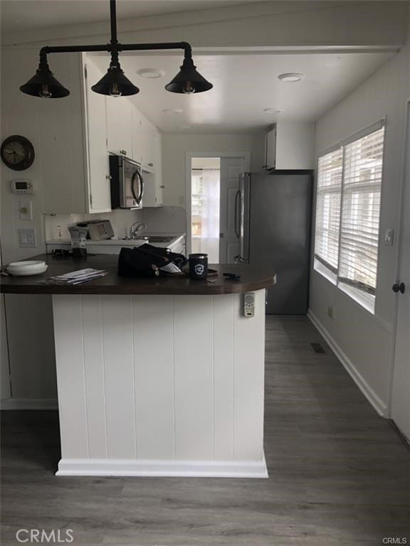 3512 Palm Ave, Manhattan Beach, CA 90266 - kitchen with appliances with stainless steel finishes, dark countertops, white cabinets, and healthy amount of natural light