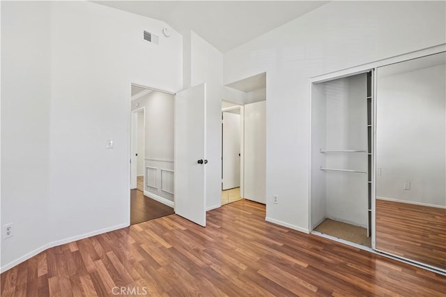27834 Lassen St, Castaic, CA 91384 - unfurnished bedroom with wood finished floors, a closet, and high vaulted ceiling