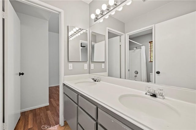 27834 Lassen St, Castaic, CA 91384 - bathroom featuring double vanity, a shower, and wood finished floors