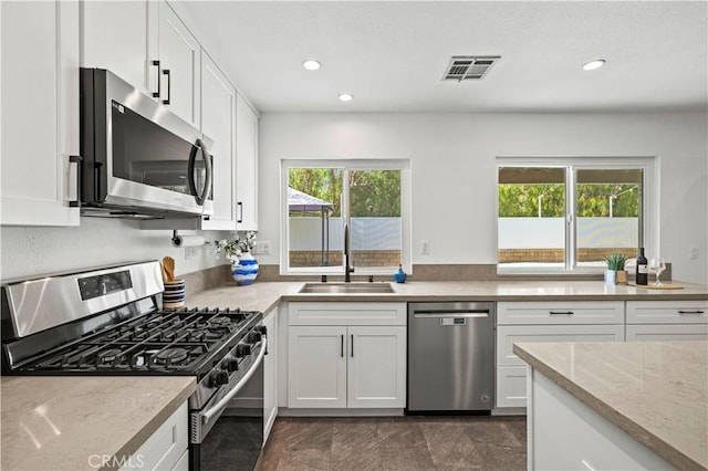 27834 Lassen St, Castaic, CA 91384 - kitchen with stainless steel appliances, white cabinetry, light stone counters, and recessed lighting