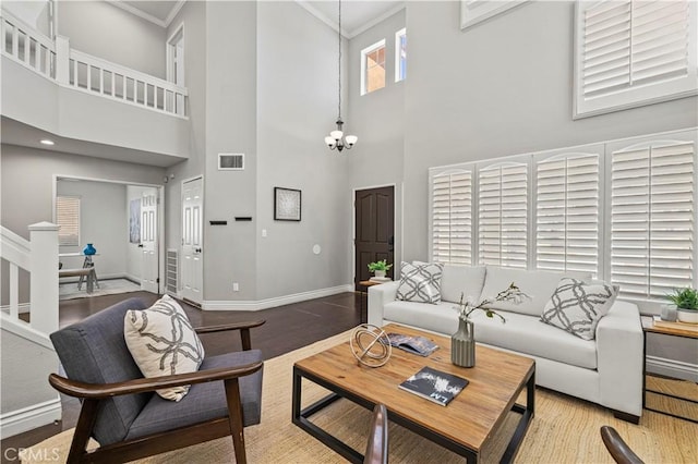 27834 Lassen St, Castaic, CA 91384 - living area featuring a high ceiling, crown molding, wood finished floors, and a chandelier
