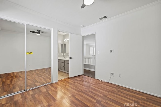 27834 Lassen St, Castaic, CA 91384 - unfurnished bedroom with wood finished floors, ornamental molding, ceiling fan, and ensuite bathroom