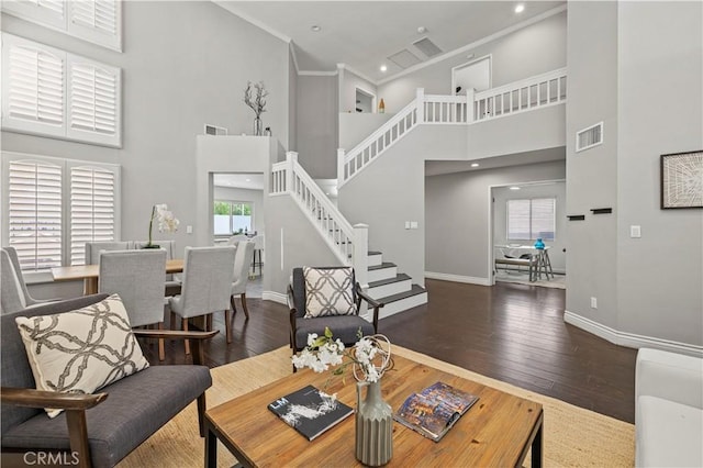 27834 Lassen St, Castaic, CA 91384 - living room with a high ceiling, hardwood / wood-style floors, stairway, and crown molding
