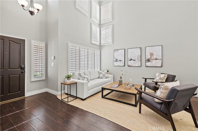 27834 Lassen St, Castaic, CA 91384 - living area with wood-type flooring, a towering ceiling, and a chandelier