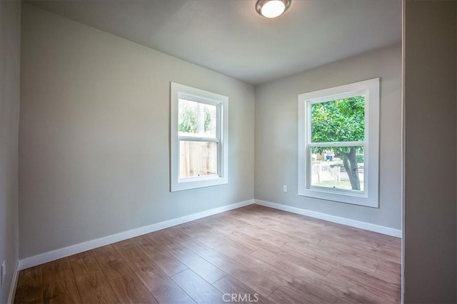 784 W 17th St, San Bernardino, CA 92405 - unfurnished room with plenty of natural light, wood finished floors, and baseboards