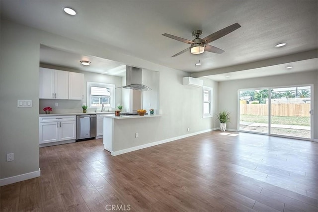 784 W 17th St, San Bernardino, CA 92405 - kitchen featuring stainless steel dishwasher, island range hood, white cabinets, ceiling fan, and healthy amount of natural light