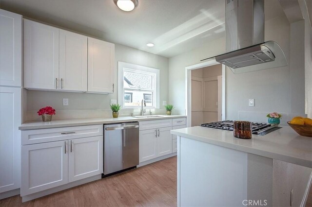 784 W 17th St, San Bernardino, CA 92405 - kitchen featuring dishwasher, wall chimney range hood, a sink, stovetop, and white cabinetry