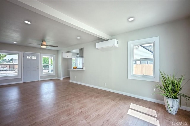 784 W 17th St, San Bernardino, CA 92405 - unfurnished living room with a wall mounted AC, wood finished floors, baseboards, recessed lighting, and ceiling fan