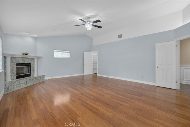 1641 Ford St, Redlands, CA 92373 - unfurnished living room with ceiling fan, lofted ceiling, wood finished floors, a premium fireplace, and baseboards
