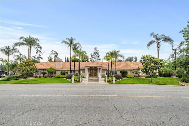 1641 Ford St, Redlands, CA 92373 - view of front facade with a tile roof, stucco siding, a chimney, and a front yard